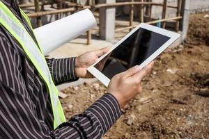 construction engineer worker using tablet computer at building site photo