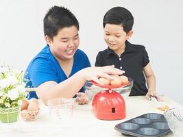 Asian boys are making cake photo