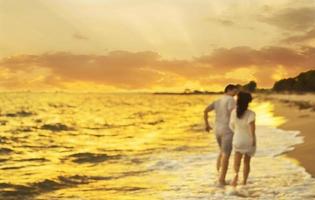 Blurred photo of  Asian couple running on beach