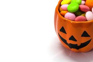 Halloween pumpkin face buckets with colorful candy photo