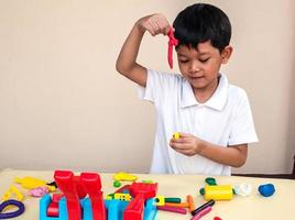 A boy is playing colorful clay photo