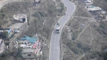 Aerial top view of traffic vehicles driving at mountains roads at Nainital, Uttarakhand, India, View from the top side of mountain for movement of traffic vehicles video