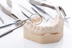 Gypsum model of jaws and dental tools photo