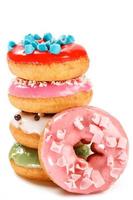 Colorful donuts on white background photo