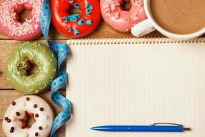 Colorful donuts and notepad photo