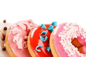 Colorful donuts on white background photo