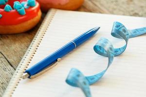 Colorful donuts and notepad photo