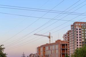 New construction site with cranes on sunset background. photo