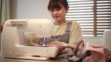 mujer usando una maquina de coser video