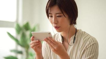 A woman studying on a smartphone video