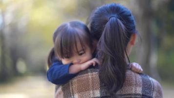 Sleepy girl embraced by her mother video