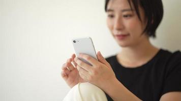 A woman operating a smartphone video