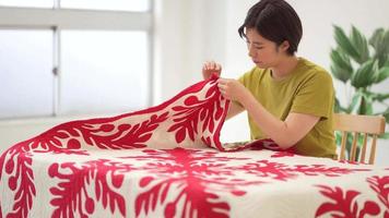 A woman making a Hawaiian quilt video