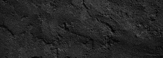 fondo de textura de piedra granulada áspera de color gris oscuro o de miedo de pared negra. hormigón negro para el fondo. foto