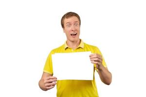 Surprised young man holding blank paper sheet, paper mockup isolated on white background photo