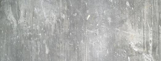 Old dirty concrete wall as a background. Gray cement plaster. Wall texture for background. Brush scratches on the wall photo