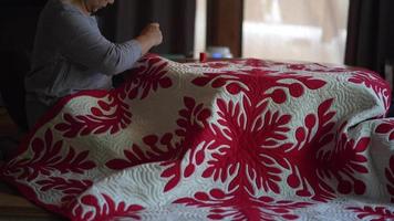 A woman making a Hawaiian quilt video