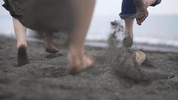 Men and women running toward the sea video