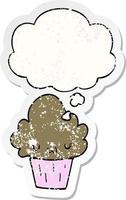 cartoon cupcake with face and thought bubble as a distressed worn sticker vector