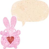 cute cartoon rabbit with love heart and speech bubble in retro textured style vector