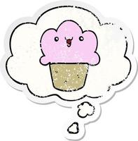 cartoon cupcake with face and thought bubble as a distressed worn sticker vector