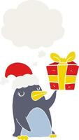 cartoon penguin with christmas present and thought bubble in retro style vector