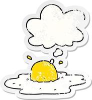 cartoon fried egg and thought bubble as a distressed worn sticker vector