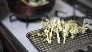 Woman frying tempura of cod buds video