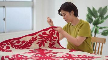 A woman making a Hawaiian quilt video