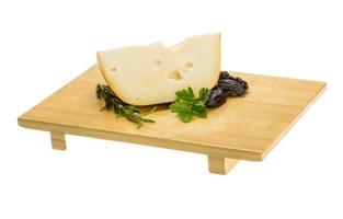 Maasdam cheese on board  isolated on white background photo