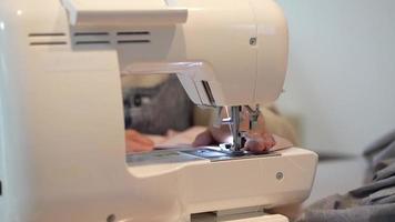 Woman using a sewing machine video