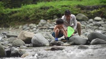 Parents and children playing in the river video