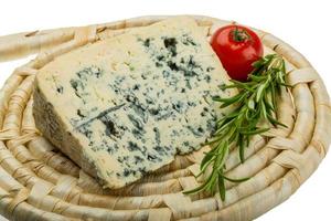 Blue cheese on board  isolated on white background photo