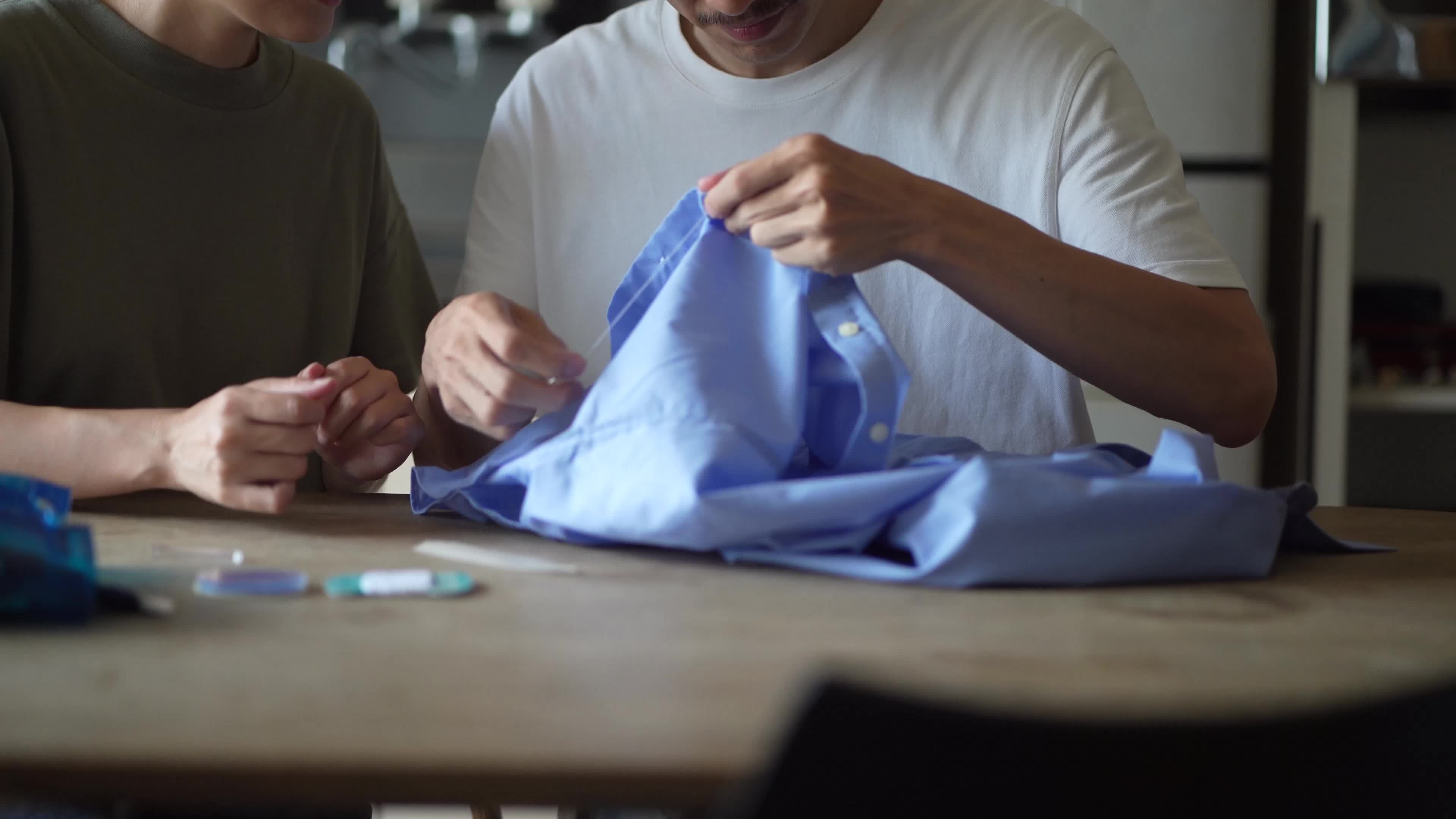 A man who learns how to attach buttons 8872531 Stock Video at Vecteezy