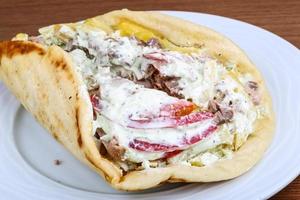 Souvlaki on the plate and wooden background photo