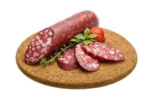 Salami sausages on wooden plate photo