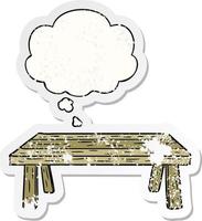 cartoon table and thought bubble as a distressed worn sticker vector