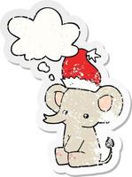 cute christmas elephant and thought bubble as a distressed worn sticker vector