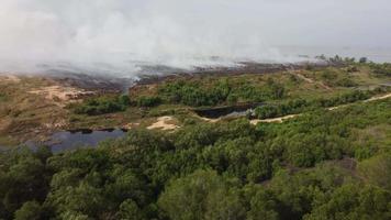 Aerial fly toward burning of garbage dump video