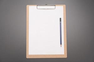 a clipboard with a white sheet of paper photo