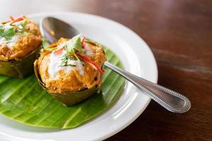 Thai Steamed Curried in Banana Leaf bowl. Thai call Homok. photo