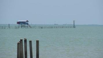 A fisherman's house located in the middle of the sea that is a shellfish farm. video