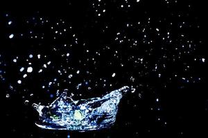 Scattered water splashes on a black background. water splash isolated on the black background photo