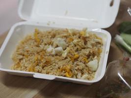 Crab meat fried rice topped with Scrambled egg, style Thai food in white paper box read to eat, take home photo