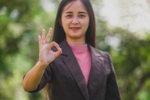 business woman doing ok sign photo