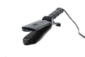 black curling iron is a beauty accessory of a woman who loves beauty in fashion and makes straight, beautiful hair a must-have accessory for young women at home. photo