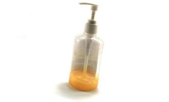 Wrinkle Treatment Facial Serum is a lotion of pure and natural extracts-mixed gold leaf-in a medium plastic bottle on a separate white background, popular with young people these days. photo