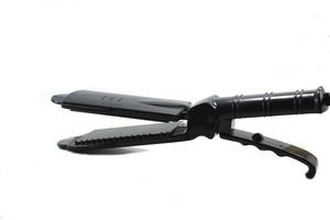 black curling iron is a beauty accessory of a woman who loves beauty in fashion and makes straight, beautiful hair a must-have accessory for young women at home. photo