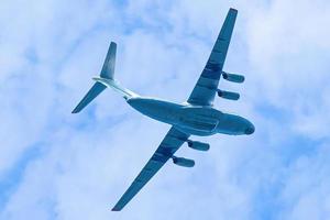 Airplane is flying in blue sky. Commercial passenger and cargo a photo