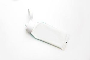 top view of used toothpaste on a white background photo